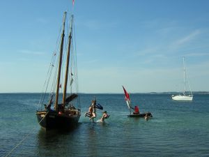 Kinder springen vom Segelboot